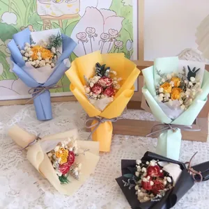 Mini dried flower bouquets with roses and gypsophila in various colored packaging
