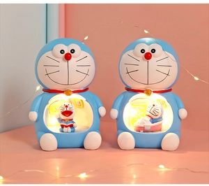 Detail of blue resin Doraemon night light with internal reading and bathing scenes