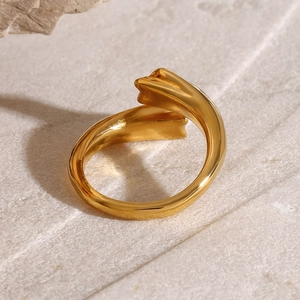 Modern twisted gold stainless steel ring with arrowhead details on grey stone