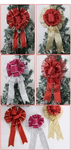 Detailed views of multi-layer glitter Christmas bows decorating a snowy tree branch
