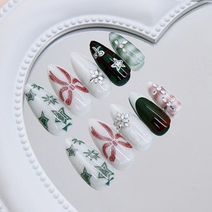 Christmas press-on nails with red-green plaid, glitter snowflake, and rhinestones