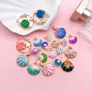 Macro shot of colorful enamel shell and starfish charms with pearls and rhinestones