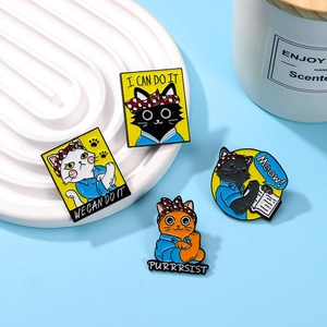 Set of four cartoon cat enamel pins with motivational quotes on blue background