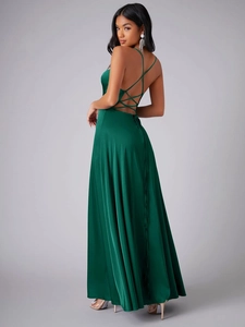 Détail de la robe en satin vert foncé montrant le dos nu et la texture des lacets croisés