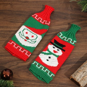 Christmas knitted wine bottle covers with Santa and snowman patterns on wood
