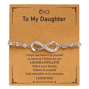 Detailed view of silver infinity bracelet with Daughter script and sparkling zircons
