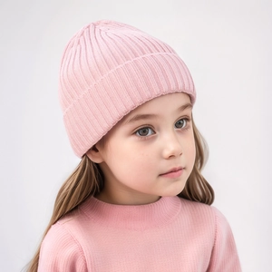 Close-up of pink knitted baby hat showing soft ribbed texture and warm yarn details