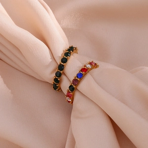 Close-up of 18K gold plated rings with micro-pave green and multicolored cubic zirconia