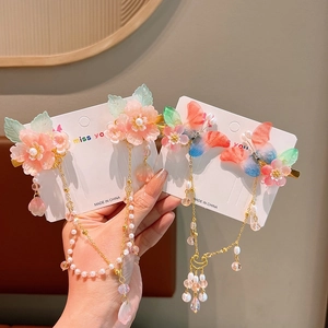 Detailed view of Chinese-style butterfly flower hair clips with soft gradient tassels
