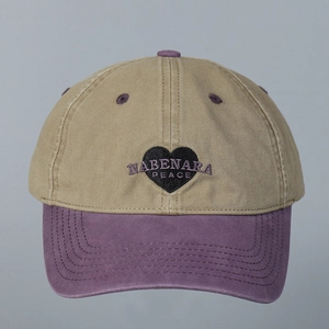 Detail of washed cotton baseball cap with heart embroidery and contrast visor