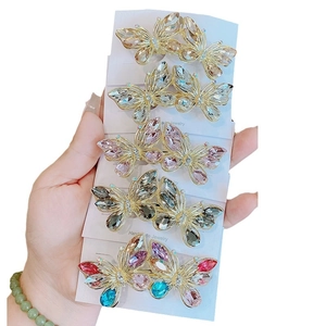 Handmade butterfly hair clips with colorful crystals on golden metal frames