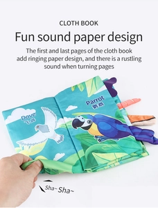 Detail of baby cloth book showing a colorful parrot and crinkle paper sound feature