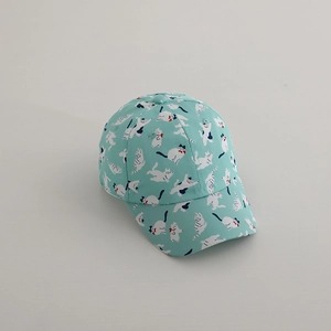 Detailed close-up of light blue kids baseball cap with cute cat pattern and red bow ties