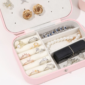 Detail view of pink PU leather jewelry box with velvet lining and earring hooks