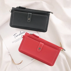 Close-up of long zip-around wallets with front snap pockets and contrast stitching