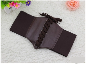 Flat lay of dark brown wide corset belt with lace-up design on white plush background