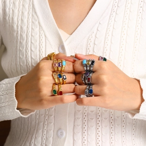 Detail of vintage square gemstone rings with textured gold and silver metal bands