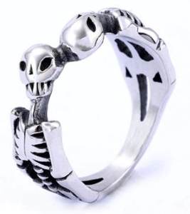 Macro detail of gothic stainless steel skeleton ring with double skull and rib design
