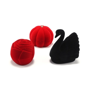 Detailed view of velvet jewelry boxes in rose, pumpkin, and swan shapes with soft texture