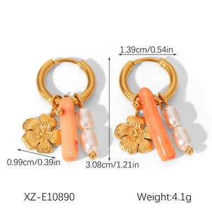 Detailed view of 18k gold plated twist earrings with pearls and coral beads