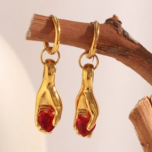 Retro 18K gold plated stainless steel hand-shaped earrings holding a red heart gemstone
