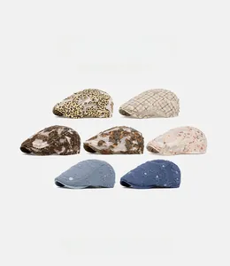 Detailed view of various leopard print and lace mesh newsboy caps for summer wear