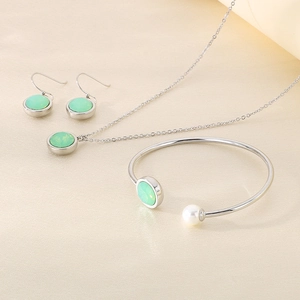 Silver stainless steel jewelry set with green circular stones and white pearl accents