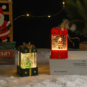 Detail of festive Christmas gift box water globe lights with LED warm glow and glitter
