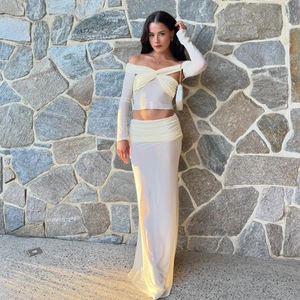 Detailed close-up of a white off-shoulder long sleeve two-piece set with ruching on model
