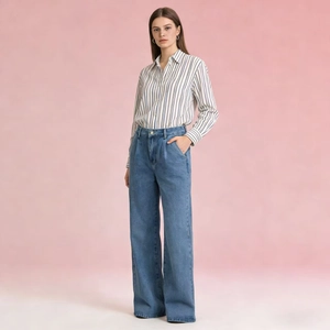 Detail of high waisted wide leg denim jeans paired with a classic blue striped shirt