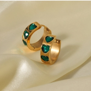 Close-up of 18K gold-plated hoop earrings with inlaid green heart-shaped zircon stones