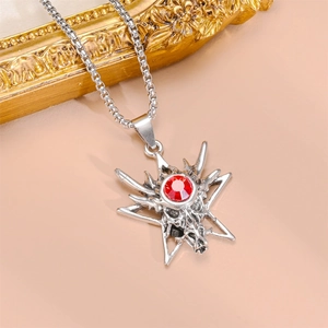 Detail of dragon head hexagram necklace with red gemstone and silver metal chain link
