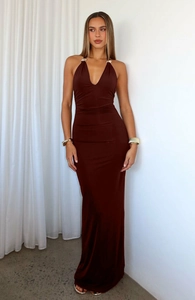 Detail of elegant deep chocolate dress with golden metal ring on halter deep V-neckline