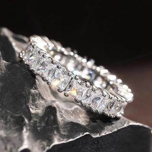 Macro shot of silver princess cut eternity band ring with cubic zirconia stones