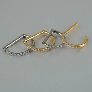 Polished D-shaped titanium nose rings with cubic zirconia in gold and silver colors