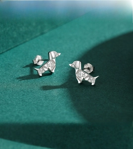 Macro shot of S925 silver dachshund stud earrings with pavé zircon origami puppy design