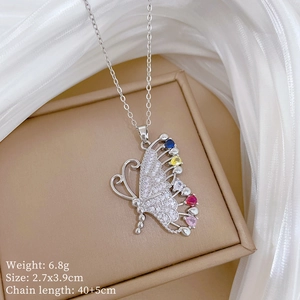 Close-up of butterfly necklace pendant with colorful gemstones and detailed product dimensions