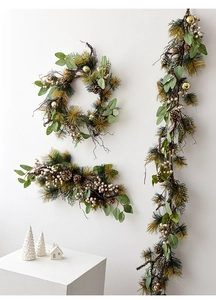 Detail of Christmas garland with faux pine needles, eucalyptus, pinecones and white berries