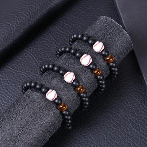 Detail of four matte black stone baseball bracelets on a professional display stand