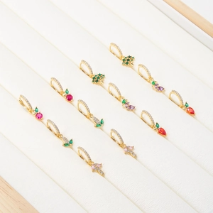 Detailed display of assorted gold-plated vegetable and fruit earrings with colorful zircon