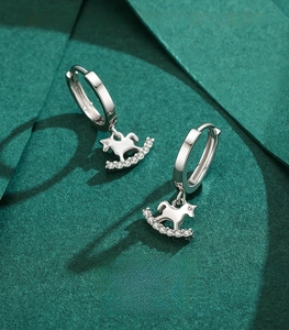 Detail of 925 sterling silver rocking horse earrings with micro-inlaid cubic zirconia
