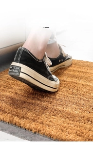 Durable natural coconut fiber doormat with non-slip backing for outdoor entrance use