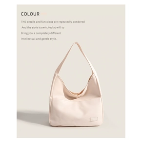 Detail of beige crescent tote bag showing smooth faux leather texture and minimalist design