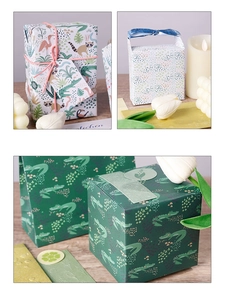 Detail of jungle animal gift wrap featuring crocodiles and flamingos with ribbons