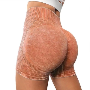High-waisted seamless orange yoga shorts with peach lift design for fitness and running
