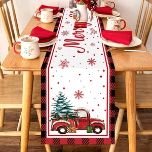Christmas table runner with red truck and tree design on white fabric with plaid border