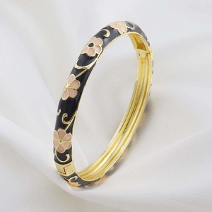 Retro style cloisonné enamel bangle with pink flowers on a sleek black gold-plated base