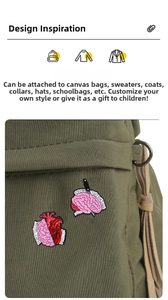Detailed view of enamel anatomy pins featuring Heart and Brain slogans on a canvas bag