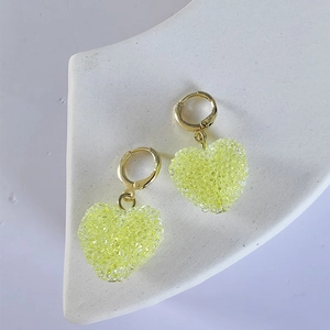 Elegant heart-shaped drop earrings with sparkling yellow crystals on gold hooks