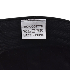 Detail shot of the 100% cotton material label and inner lining on the black sun hat